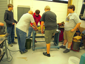 Cutting cylinder metal on shears.