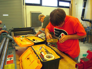 Shaping tank bottom on stake.