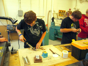 Soldering tank top to tank bottom.