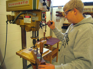 Drilling lens cylinder hole in lantern door.