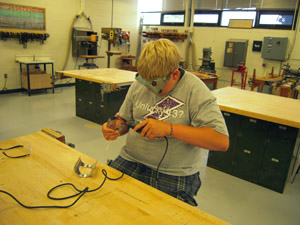 Sanding lens cylinder to fit lantern door.