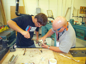 Soldering door hinges to outside cylinder.