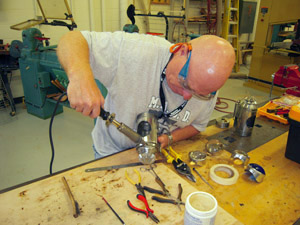 Soldering frustum to cylinder.